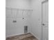 Laundry room with washer/dryer hookups, wire shelving, and vinyl floors at 40706 E Ninth Ave, Umatilla, FL 32784