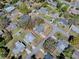 An aerial view displays the property lines of this home, nestled among lush trees in a quiet neighborhood at 481 Belle Ayre Dr, Mount Dora, FL 32757