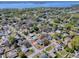 Aerial view of a beautiful property showcasing a charming home with a red-lined yard in a serene, tree-filled neighborhood at 481 Belle Ayre Dr, Mount Dora, FL 32757