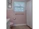 Bathroom featuring pink tile, a window, and a shower with a white curtain at 481 Belle Ayre Dr, Mount Dora, FL 32757