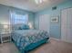 Bedroom with a light blue color scheme, ceiling fan, and a large bed at 481 Belle Ayre Dr, Mount Dora, FL 32757