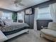 Bedroom with gray walls, ceiling fan, and a decorative side chair by the window at 481 Belle Ayre Dr, Mount Dora, FL 32757