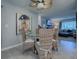 Cozy dining area features a glass-top table, wicker chairs and a view into the living room at 481 Belle Ayre Dr, Mount Dora, FL 32757