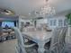 Elegant dining room with a chandelier and a view into the kitchen and living spaces at 481 Belle Ayre Dr, Mount Dora, FL 32757