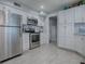 Bright kitchen features stainless steel appliances, white cabinets, and a view to another room at 481 Belle Ayre Dr, Mount Dora, FL 32757