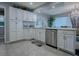 Kitchen with white cabinetry, modern stainless steel appliances, and view of a dining nook at 481 Belle Ayre Dr, Mount Dora, FL 32757