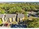 Aerial view of the apartment building with parking and surrounding trees at 5255 Images Cir # 207, Kissimmee, FL 34746