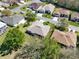 Aerial view of homes showing mature landscaping and outdoor patios in a well-manicured community at 5645 Huntington St, Leesburg, FL 34748