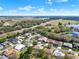 Expansive aerial view of homes in community with lush landscaping, lakes and sunny blue skies at 5645 Huntington St, Leesburg, FL 34748