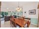 Open dining room featuring a wooden table, flowing into the living area with comfortable seating at 5645 Huntington St, Leesburg, FL 34748