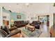 Expansive living room featuring leather sofas, a dining area, and a neutral color palette at 5645 Huntington St, Leesburg, FL 34748