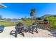 Outdoor seating area with grill overlooking a beautiful pond at 5835 Hensley Ave, The Villages, FL 32163