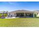 Aerial view of the backyard with screened in patio and outdoor seating space at 5835 Hensley Ave, The Villages, FL 32163