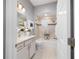 Bright bathroom with a vanity sink, toilet, and a shower with dual showerheads at 5835 Hensley Ave, The Villages, FL 32163