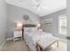 Cozy bedroom with a ceiling fan, a queen-size bed and neutral decor at 5835 Hensley Ave, The Villages, FL 32163