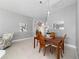 Cozy dining room with a classic wood table and views into the living room and kitchen at 5835 Hensley Ave, The Villages, FL 32163