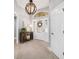 Bright foyer boasts modern light fixture, neutral walls, and tile flooring at 5835 Hensley Ave, The Villages, FL 32163