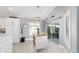 Well-lit breakfast nook adjacent to the modern kitchen, with sliding glass door to outdoor patio at 5835 Hensley Ave, The Villages, FL 32163