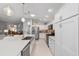 Spacious kitchen featuring white cabinetry, stainless steel appliances, and a large quartz island at 5835 Hensley Ave, The Villages, FL 32163