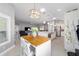 Open concept layout showcasing the kitchen island and view of the living room with vaulted ceilings at 5835 Hensley Ave, The Villages, FL 32163