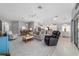 Bright, open-concept living room featuring modern finishes, neutral colors, tile floors, and lots of natural light at 5835 Hensley Ave, The Villages, FL 32163