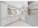 Main bathroom featuring double sinks, white cabinetry, a walk-in shower, and neutral decor at 5835 Hensley Ave, The Villages, FL 32163