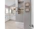 Main bathroom featuring double sinks, white cabinetry, a walk-in shower, and neutral decor at 5835 Hensley Ave, The Villages, FL 32163