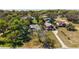 Aerial view showcasing a beautiful neighborhood with mature trees, and water views at 603 N Lakeshore Blvd, Howey In The Hills, FL 34737