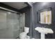 Bathroom featuring a glass shower, pedestal sink and mirror at 603 N Lakeshore Blvd, Howey In The Hills, FL 34737