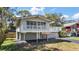 Stunning two-story home featuring a wraparound balcony at 603 N Lakeshore Blvd, Howey In The Hills, FL 34737