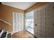 Welcoming foyer with tile floors, closet, and stairs leading to the upper level at 603 N Lakeshore Blvd, Howey In The Hills, FL 34737