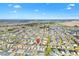 Aerial view showing home's proximity to a distant landmark amid a well-established residential area at 6088 Keckonen Dr, The Villages, FL 32163