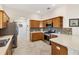 Well-lit kitchen features tile floors, stainless steel appliances, and wooden cabinets at 6088 Keckonen Dr, The Villages, FL 32163