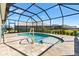 Beautiful backyard pool with screened enclosure, and well-manicured landscaping at 6088 Keckonen Dr, The Villages, FL 32163