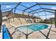 Private kidney-shaped pool with screened enclosure, and inviting patio area at 6088 Keckonen Dr, The Villages, FL 32163