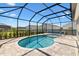 Sparkling pool with screened-in enclosure, offering a relaxing outdoor space at 6088 Keckonen Dr, The Villages, FL 32163