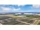 Wide aerial shot showing a large agricultural landscape with a lake at 6856 Perch Hammock Loop, Groveland, FL 34736