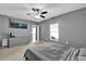 This bedroom has a TV, ceiling fan, and a neutral color palette at 6856 Perch Hammock Loop, Groveland, FL 34736