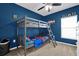 Fun bedroom featuring a bunkbed and a blue accent wall at 6856 Perch Hammock Loop, Groveland, FL 34736