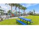 Beautiful community pool with lush green space, picnic table, colorful splash zone and seating at 6856 Perch Hammock Loop, Groveland, FL 34736