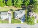An aerial view of the home showing backyard patio and mature landscaping at 9025 Se 136Th Loop, Summerfield, FL 34491
