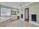 Bright bathroom with tiled floor, large vanity, and a glass block window over the tub at 9025 Se 136Th Loop, Summerfield, FL 34491