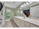 Well-lit bathroom featuring a large vanity with white cabinets, a spacious countertop, and light-green walls at 9025 Se 136Th Loop, Summerfield, FL 34491