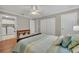 Bedroom boasts a laundry room access, ample closet space, ceiling fan and wood floors at 9025 Se 136Th Loop, Summerfield, FL 34491