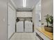 Laundry room with washer and dryer hookups, overhead cabinets, and tile flooring at 9025 Se 136Th Loop, Summerfield, FL 34491