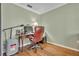 Office space featuring wood floors, ample lighting, and a work desk and chair at 9025 Se 136Th Loop, Summerfield, FL 34491
