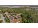 Aerial view of a residential area with mature trees and beautiful lakes providing a serene backdrop at 906 Shady Canyon Way, Poinciana, FL 34759