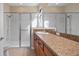 Bright bathroom featuring a glass-enclosed shower and a vanity with ample counter space at 906 Shady Canyon Way, Poinciana, FL 34759