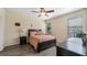 Well-lit bedroom with wood-look flooring, ceiling fan, and a serene ambiance at 906 Shady Canyon Way, Poinciana, FL 34759