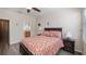 Well-lit bedroom with wood-look flooring, ceiling fan, neutral colors, and natural lighting at 906 Shady Canyon Way, Poinciana, FL 34759